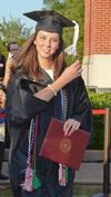 Katie Mohler, history graduate, leaves the stage after receiving her degree during spring graduation. - Photo by Morris Abernathy