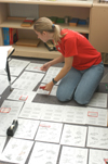 Sophomore Psychology major Emily Boecking helps a teacher organize her classroom at Parkview Montessori during Day of Remembrance 2003. - Photo by Jonathan Blair