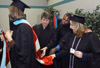 Graduates make last second preparations for Fall Graduation 2003. Sheila Ferrell, MAEd graduate from Ripley, Tenn. is attended to by Kathie Cothern, MAEd graduate from Jackson, Tenn.; Everett Singleton, MAEd graduate from Brownsville, Tenn.; and Sharon Markham, MSN graduate from Eads, Tenn. - Photo by Jim Veneman