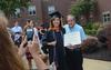 Rhonda Kaye Litano celebrates with her father after receiving her master of science in nursing at Union's summer graduation ceremony. - Photo by Morris Abernathy