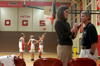Senior Cherry Johnson, Christian studies major, prepares the stats book for a Lady Bulldogs basketball game on Nov. 21. She confers with Leigh Ann Simmons, sports trainer, while the Lady Bulldogs practice in the background. - Photo by Jonathan Blair