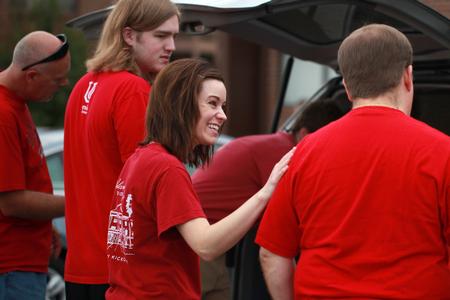 Joy Greene, assistant director of experiential education, talks to the family of a new student before unloading their car during New Student Move-in. 