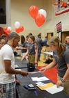Emily Smith, junior nursing major, helps Ponci Cobb, freshman pre-med major, in filling out registration forms during New Student Move-in.  - Photo by Zac Calvert
