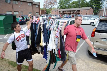 Daniel Decker, sophomore biology and pre-med major, and Evan Cantrell, sophomore youth ministry major, help by carrying a rack of clothes during New Student Move-in.