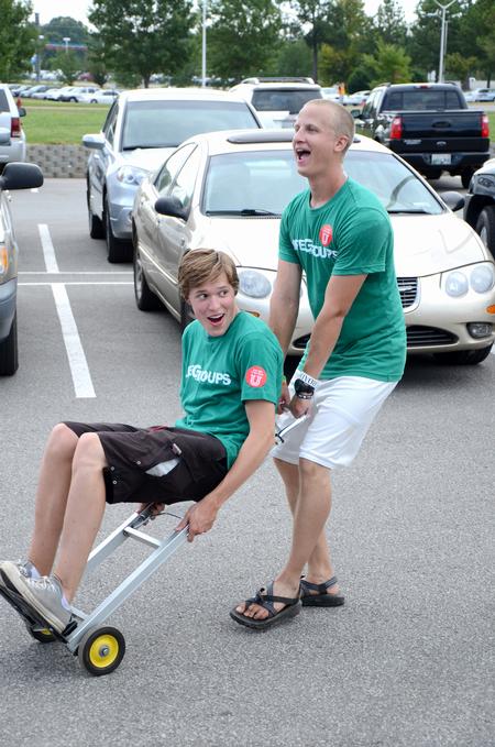 Sophomore Peter Riggs rides a dolly cart pushed by Ben Wright, sophomore dms major, during New Student Move-in.