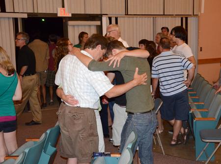 Families spend time together at the end of the New Student and Parent Worship Service in the GM Savage Memorial Chapel.