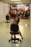 Karli Schumaker, freshman pre-med major, plays in a rolling chair race with her focus group during Focus week. - Photo by Zac Calvert