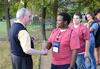 David S. Dockery, president of the university, shakes hands with freshman Kael Moore during an ice cream social held outside the Dockery's home. - Photo by Jacob Moore