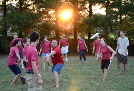 New students enjoy a game of Frisbee during the annual ice cream social outside the home of David and Lanese Dockery.