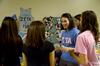 Lily Coursey, junior elementary education major, encourages incoming freshman girls to rush during Greek recruitment at the Student Activity Fair. - Photo by Ebbie Davis