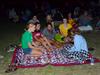 Students share a laugh during Movie on the Lawn, hosted by SAC.  - Photo by Ebbie Davis