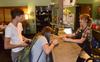Freshmen Rachel Hudspeth and Nick Fleming use the new credit card reader at Barefoots Joe while being served by barista Kathleen Hartsfield, sophomore public relations major. - Photo by Jacob Moore