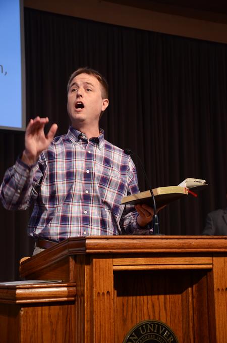 Chris Mathews, chair of the department of music, leads the congregation in music during chapel.