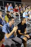 Dani Marti, junior international business major, and Pedro Faller, freshman business administration major, cheer on the men's soccer team as they play Notre Dame College. - Photo by Zac Calvert