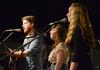 TJ Hester, senior philosophy major, sings alongside sophomores Julie Hembree and Hilary Borden during an opening act for folk-pop band Seryn. - Photo by Jacob Moore