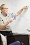 James Kirk, associate professor of computer science, shows students how to work a problem on the board. - Photo by Kristi McMurry
