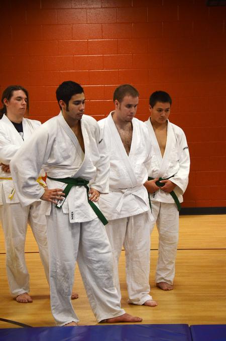 Zach Preston, Stephan Rabenhorst, Jonathan Rogers, and Peter Yu watch as judo instructor Mario Melendez shows the club the proper way to fall to the ground. 