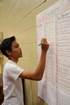 James Vo, freshman chemistry major, signs his team up for the Resident Life Treasure Hunt across campus. - Photo by Zac Calvert