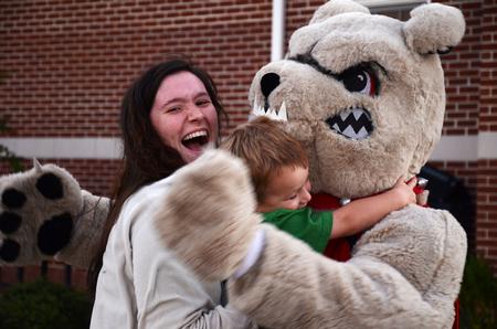 Mindy Winters, sophomore psychology major hugs Buster the bulldog during the Make-a-wish cookout for Family Weekend. 