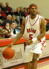 Union's freshman point guard Marcus Cooper (5) surveys the defense as he moves the ball up the floor. - Photo by Courtney Ross
