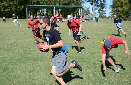 Dylan Baker, junior engineering major, runs down the field during a game of flag football on Family Weekend.