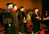 Richard Joiner, Todd Brady, Carla Sanderson, and President David S. Dockery stand as the faculty files into the chapel during Fall Convocation 2002. - Photo by Jim Veneman