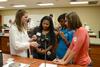 Pharmacy student Ashley Pugh explains a demonstration to prospective students visiting the School of Pharmacy. - Photo by Jacob Moore