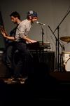 Jay Griffith and Rob Griffith, sophomore English majors, perform along with the band Flying Colours in Barefoots Joe.  - Photo by Anne Richoux