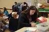 During Campus and Community Day, Emily Williams, freshman elementary education major, writes a note to put inside an Operation Christmas Child box going to a child in need.  - Photo by Anne Richoux