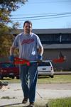 Keith Bates, associate professor of history, uses a weed eater outside of the Bemis Mill Village Museum during Campus and Community Day.  - Photo by Zac Calvert