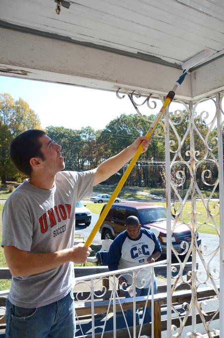 Jamie Fox, freshman math major, paints a local woman's porch as part of Union's ninth annual Campus and Community Day.