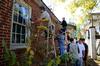 Students volunteer at a local home by painting, fixing gutters, scraping and re-painting during Union's ninth annual Campus and Community Day. - Photo by Ebbie Davis