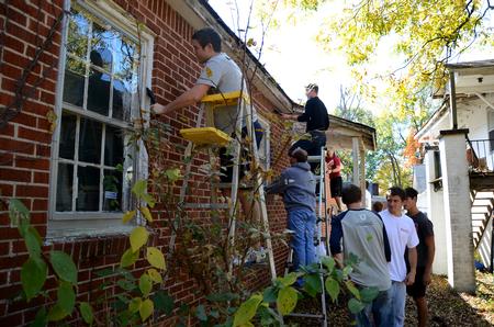 Students volunteer at a local home by painting, fixing gutters, scraping and re-painting during Union's ninth annual Campus and Community Day.