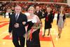 Andi Schreiber, senior family studies major, is escorted by her father, Mike Schreiber, after being crowned as the 2011 Homecoming Queen. - Photo by Jacob Moore