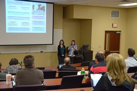 Jennifer Escue and Louisa Saratora, who serve with Catholic Charities of Tennessee, speak at the "Culture and Crisis" Town and Gown lecture series. 