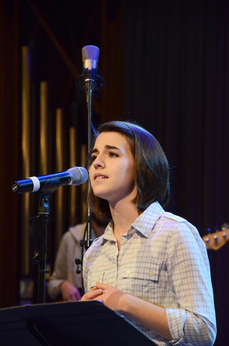 Natalie Wittman,senior spanish major, leads the crowd in a song during chapel.
