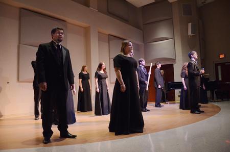 Proclamation performs in Hartley Recital Hall, using small instruments and shakers while singing. 