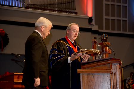 David S. Dockery, president of the university, presents the Robert E. Craig Service Award to Lloyd Hansen at the 2011 Fall Commencement Services held at West Jackson Baptist Church.