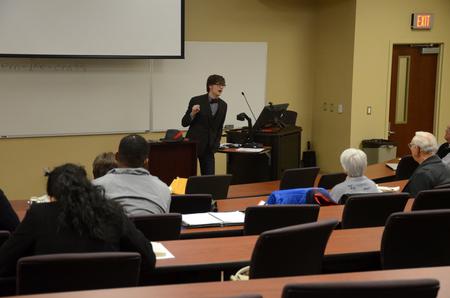 Students, employees, and community members listen as Greg Thornbury, dean of the school of theology and missions and vice president for spiritual life, speaks at the Town & Gown: Media, Politics, & Democracy lecture series. 