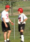 Union head coach Brian Dunn talks with the baserunner, Allison Shein from the third base coach's box. - Photo by Heidi Davis