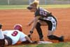 Christina Johnson (9) slides around to tag to reach third base safely. - Photo by Heidi Davis