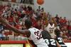 Lavanda Ross passing the ball to teammate Mildred Olumasi. - Photo by Morris Abernathy