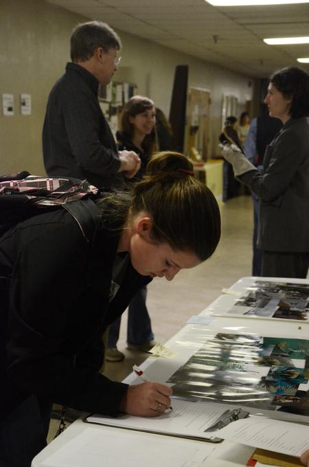 Sam Howard, junior chemistry major, signs up for more information at the external study fair in the Penick Academic Complex. 
