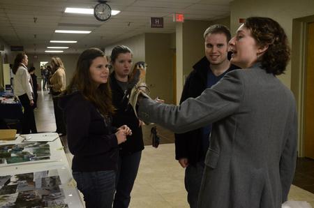Sarah Porter, Sam Howard, and Jonathan Rogers talk with Jennifer Gruenke, associate professor of biology, during the external study fair.