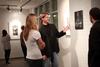 Steve Halla, assistant professor of art, talks with students about his woodcuts on display in the art gallery. - Photo by Kristi McMurry