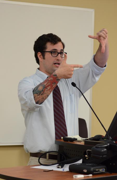 Aaron Hardin, photographer for <em>The Jackson Sun</em>, speaks during the Town & Gown lecture series on the role photojournalism plays in the community related to politics and democracy.