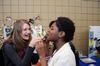 Ruth Bone, freshman nursing major, gives  to Monique Dailey, junior elementary education major, a taste of seaweed from Thailand during CutureFEST. - Photo by Zac Calvert