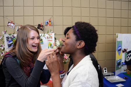 Ruth Bone, freshman nursing major, gives  to Monique Dailey, junior elementary education major, a taste of seaweed from Thailand during CutureFEST.
