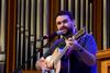 Ben Williams, member of Christ Community Church, leads music during chapel. - Photo by Jacob Moore