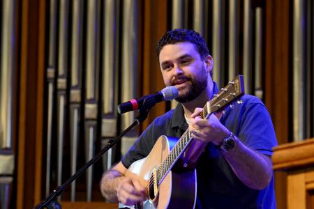 Ben Williams, member of Christ Community Church, leads music during chapel.